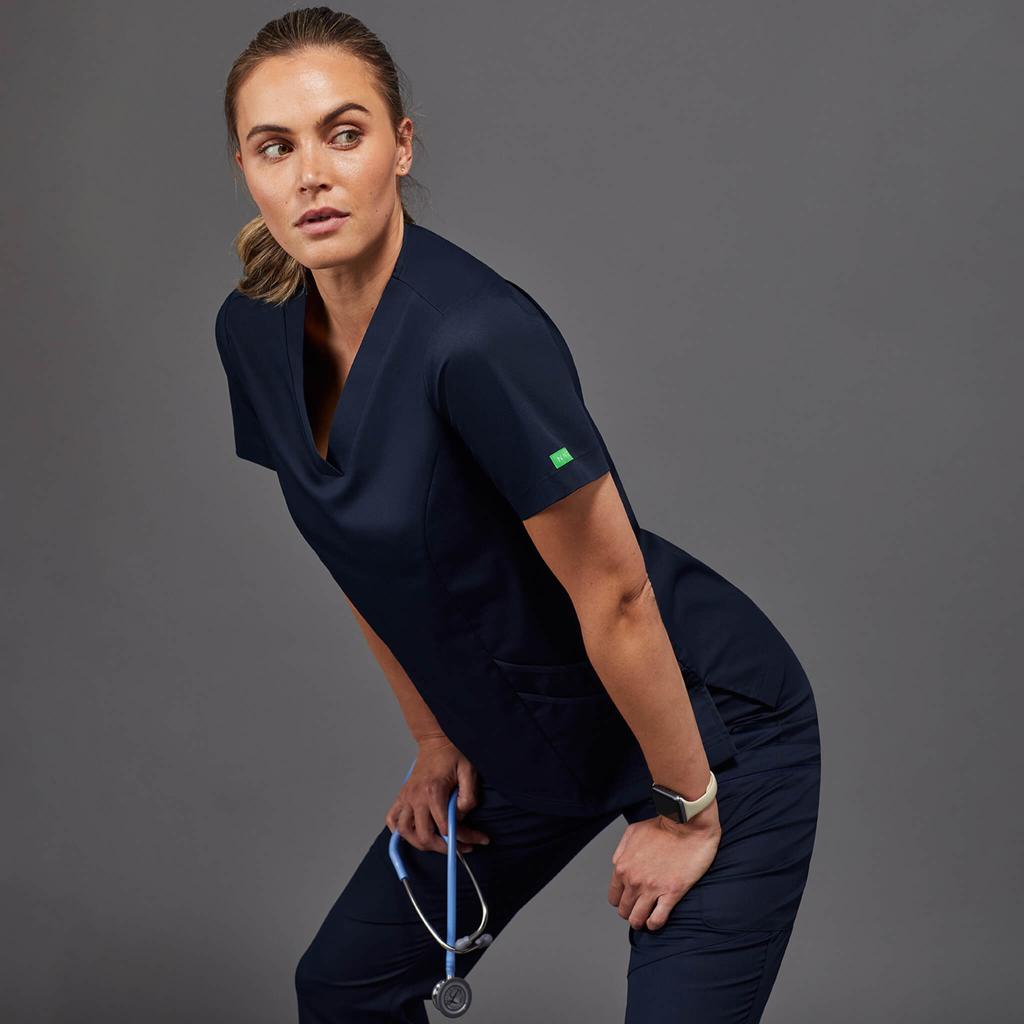 Healthcare professional wearing navy V-neck medical scrubs